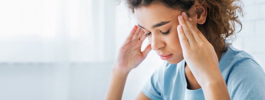Woman experiencing chronic headaches